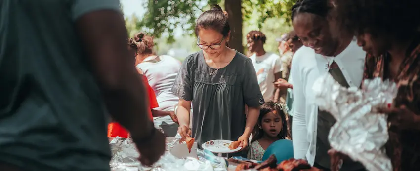 Happy family enjoying backyard barbecue party